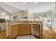 This light-filled kitchen offers warm wood cabinetry, a tile backsplash and an eat-in area at 10809 Grassy Creek Pl, Raleigh, NC 27614