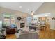 Spacious living room featuring a fireplace, hardwood floors, and multiple windows at 10809 Grassy Creek Pl, Raleigh, NC 27614