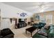 Cozy living room with a ceiling fan, fan paraphernalia, ample seating, and entertainment setup at 10809 Grassy Creek Pl, Raleigh, NC 27614