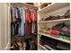 Organized walk-in closet with hanging rods and shelving for optimal storage and convenience at 10809 Grassy Creek Pl, Raleigh, NC 27614