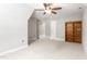 Bedroom featuring neutral walls, carpet, ceiling fan, bookcase, and door at 1084 Wild Briar Ln, Stem, NC 27581