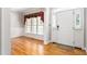 Inviting foyer featuring hardwood floors and elegant wainscoting at 1084 Wild Briar Ln, Stem, NC 27581