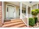 Close-up of front porch with brick steps and a white railing at 1084 Wild Briar Ln, Stem, NC 27581