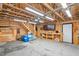 Large garage with overhead lighting, exposed rafters and a workbench at 1084 Wild Briar Ln, Stem, NC 27581