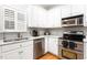 Updated kitchen with stainless appliances, granite countertops and white cabinets at 1084 Wild Briar Ln, Stem, NC 27581