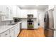 Modern kitchen with stainless steel appliances, granite countertops, and hardwood floors at 1084 Wild Briar Ln, Stem, NC 27581