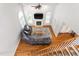 Bright living room with hardwood floors, fireplace, and large windows at 1084 Wild Briar Ln, Stem, NC 27581