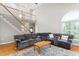 Open living room featuring a cozy seating arrangement, fireplace, and staircase to the second floor at 1084 Wild Briar Ln, Stem, NC 27581