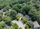 An aerial view of a neighborhood surrounded by mature trees, showcasing a serene community setting at 109 N Fern Abbey Ln, Cary, NC 27518