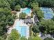 Overhead shot featuring two pools, a clubhouse, and tennis courts with mature trees throughout the community at 109 N Fern Abbey Ln, Cary, NC 27518