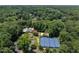 Aerial view showcases community amenities, including a pool, tennis courts, and lush green spaces at 109 N Fern Abbey Ln, Cary, NC 27518