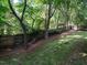Lush backyard with a wooded fence line, providing privacy and a peaceful outdoor space at 109 N Fern Abbey Ln, Cary, NC 27518