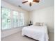 Cozy bedroom with a large window, white carpet, and a comfortable bed, filled with natural light at 109 N Fern Abbey Ln, Cary, NC 27518
