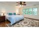 Bright bedroom with hardwood floors, ceiling fan, and large windows at 109 N Fern Abbey Ln, Cary, NC 27518