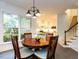 Breakfast area adjacent to kitchen with an outdoor view and stairs leading to the upper level at 109 N Fern Abbey Ln, Cary, NC 27518