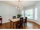 Traditional dining room featuring hardwood floors, elegant lighting, and large windows for natural light at 109 N Fern Abbey Ln, Cary, NC 27518