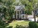 Charming brick home featuring an arched entryway and lush landscaping, perfect for curb appeal at 109 N Fern Abbey Ln, Cary, NC 27518