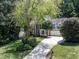 Beautiful home with a long driveway, mature trees, and a well-manicured lawn offers privacy and space at 109 N Fern Abbey Ln, Cary, NC 27518