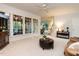 Bright living room with carpet, large windows, and access to other rooms at 109 N Fern Abbey Ln, Cary, NC 27518