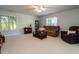 Spacious living room with plenty of seating, natural light, and a modern ceiling fan, perfect for entertaining at 109 N Fern Abbey Ln, Cary, NC 27518