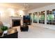 Bright living room features a brick fireplace, large windows, and a ceiling fan at 109 N Fern Abbey Ln, Cary, NC 27518
