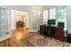 Well-lit office space with hardwood floors, an area rug, and glass paneled doors at 109 N Fern Abbey Ln, Cary, NC 27518