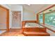 Bright bathroom featuring a sunken jacuzzi tub, natural lighting, wood flooring, and a walk-in shower at 110 Wolfs Trl, Chapel Hill, NC 27516