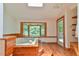 Bright bathroom featuring a sunken jacuzzi tub, natural lighting, and wood flooring at 110 Wolfs Trl, Chapel Hill, NC 27516