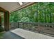 Covered deck overlooking the peaceful wooded scenery, perfect for enjoying a relaxing evening outside at 110 Wolfs Trl, Chapel Hill, NC 27516