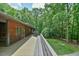 Elevated wooden deck overlooking a lush green space, perfect for enjoying the natural surroundings and outdoor living at 110 Wolfs Trl, Chapel Hill, NC 27516