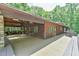 Expansive wooden deck offering ample space for entertaining, and relaxing with views of surrounding trees at 110 Wolfs Trl, Chapel Hill, NC 27516