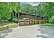 Beautiful multi-level home with dual garage doors and balconies surrounded by mature trees at 110 Wolfs Trl, Chapel Hill, NC 27516