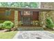 Charming front entrance featuring stone accents, wood siding, and well-maintained landscaping at 110 Wolfs Trl, Chapel Hill, NC 27516