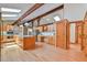Bright kitchen with wooden beams, cabinets, hardwood floors, and a central island, perfect for cooking at 110 Wolfs Trl, Chapel Hill, NC 27516