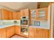 Well-appointed kitchen features wood cabinets, quartz counters, and built-in stainless steel appliances at 110 Wolfs Trl, Chapel Hill, NC 27516