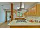 The kitchen features wood cabinets, laminate floors, and stainless steel appliances at 110 Wolfs Trl, Chapel Hill, NC 27516