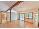 Sunny living room with hardwood floors, beamed ceilings, and a sliding door at 110 Wolfs Trl, Chapel Hill, NC 27516
