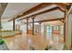 Spacious living room featuring hardwood floors, beamed ceilings, and an open layout at 110 Wolfs Trl, Chapel Hill, NC 27516