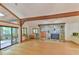 Inviting living room with stone fireplace, hardwood floors, and access to an outdoor patio at 110 Wolfs Trl, Chapel Hill, NC 27516