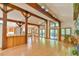 Bright living room with hardwood floors, beamed ceilings, and access to an outdoor deck at 110 Wolfs Trl, Chapel Hill, NC 27516