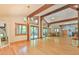 Expansive living room with hardwood floors, beamed ceilings, and access to the outdoor deck at 110 Wolfs Trl, Chapel Hill, NC 27516