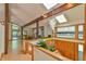Bright living room featuring a stone fireplace, skylights, and an open floor plan at 110 Wolfs Trl, Chapel Hill, NC 27516