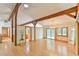 Open living room with hardwood floors, beamed ceilings, and a view into the kitchen area at 110 Wolfs Trl, Chapel Hill, NC 27516