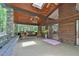 The patio features wooden beams, ceiling fans, stone columns, and rocking chairs at 110 Wolfs Trl, Chapel Hill, NC 27516