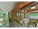 The patio features wooden beams, ceiling fans, stone columns, and rocking chairs at 110 Wolfs Trl, Chapel Hill, NC 27516
