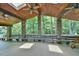 Expansive covered porch with stone pillars, wooden ceiling, built-in benches, and ample space for relaxing at 110 Wolfs Trl, Chapel Hill, NC 27516