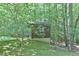 A quaint storage shed nestled amongst mature trees at 110 Wolfs Trl, Chapel Hill, NC 27516
