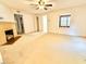 Spacious living room with a decorative fireplace and ceiling fan at 1112 N Driver St, Durham, NC 27701