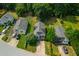 Aerial view of houses with tree-lined streets on a sunny day, showcasing the community and landscaping at 1138 Ricochet Dr, Raleigh, NC 27610