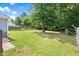 Expansive, grassy backyard with mature trees and a charming deck, perfect for outdoor enjoyment at 1138 Ricochet Dr, Raleigh, NC 27610